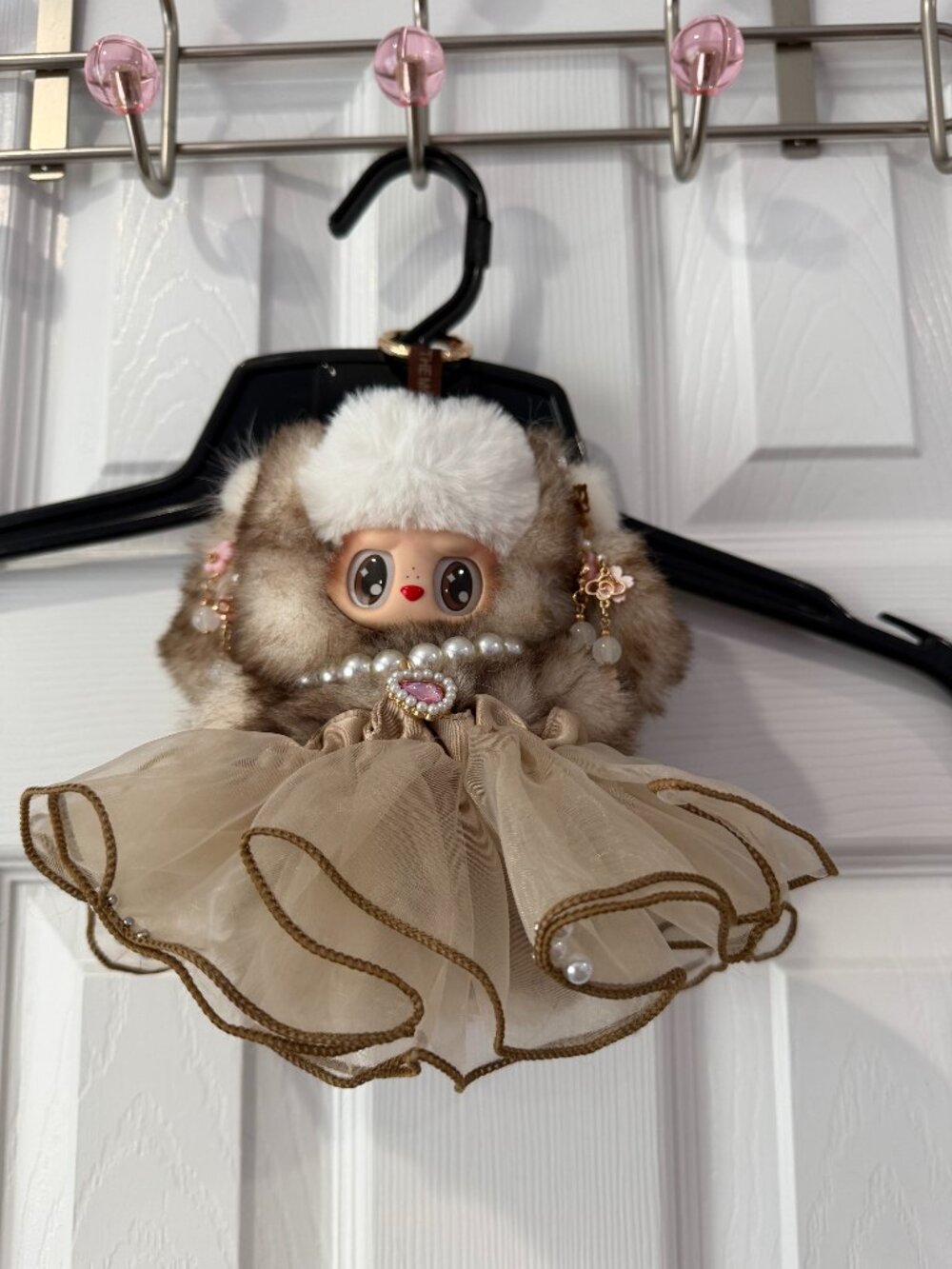 the monsters doll brown and white , necklace and skirt